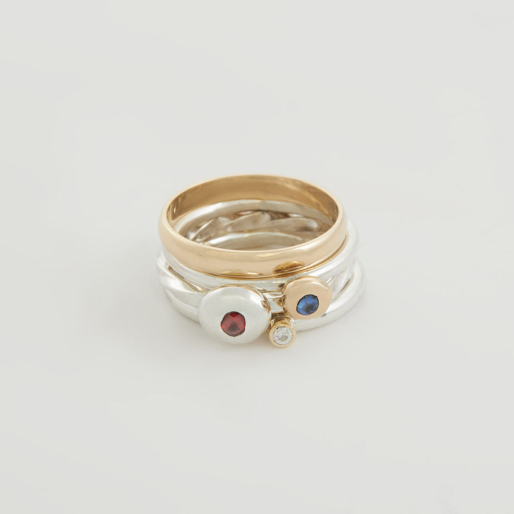 One Gold And Three Silver Stacking Rings With A Ruby, A Blue Sapphire And A Diamond