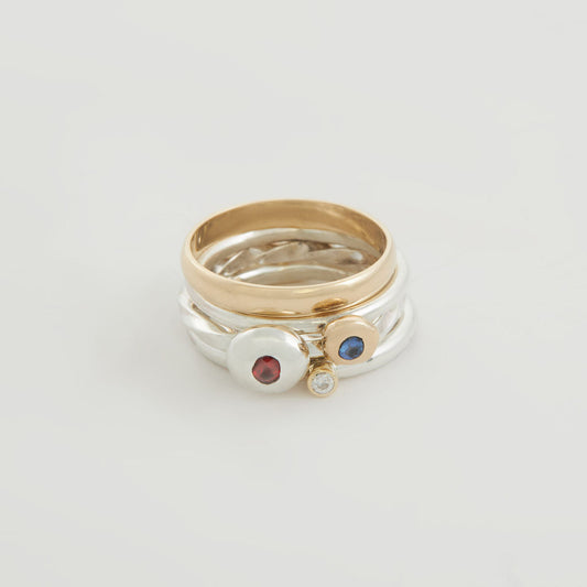 One Gold And Three Silver Stacking Rings With A Ruby, A Blue Sapphire And A Diamond